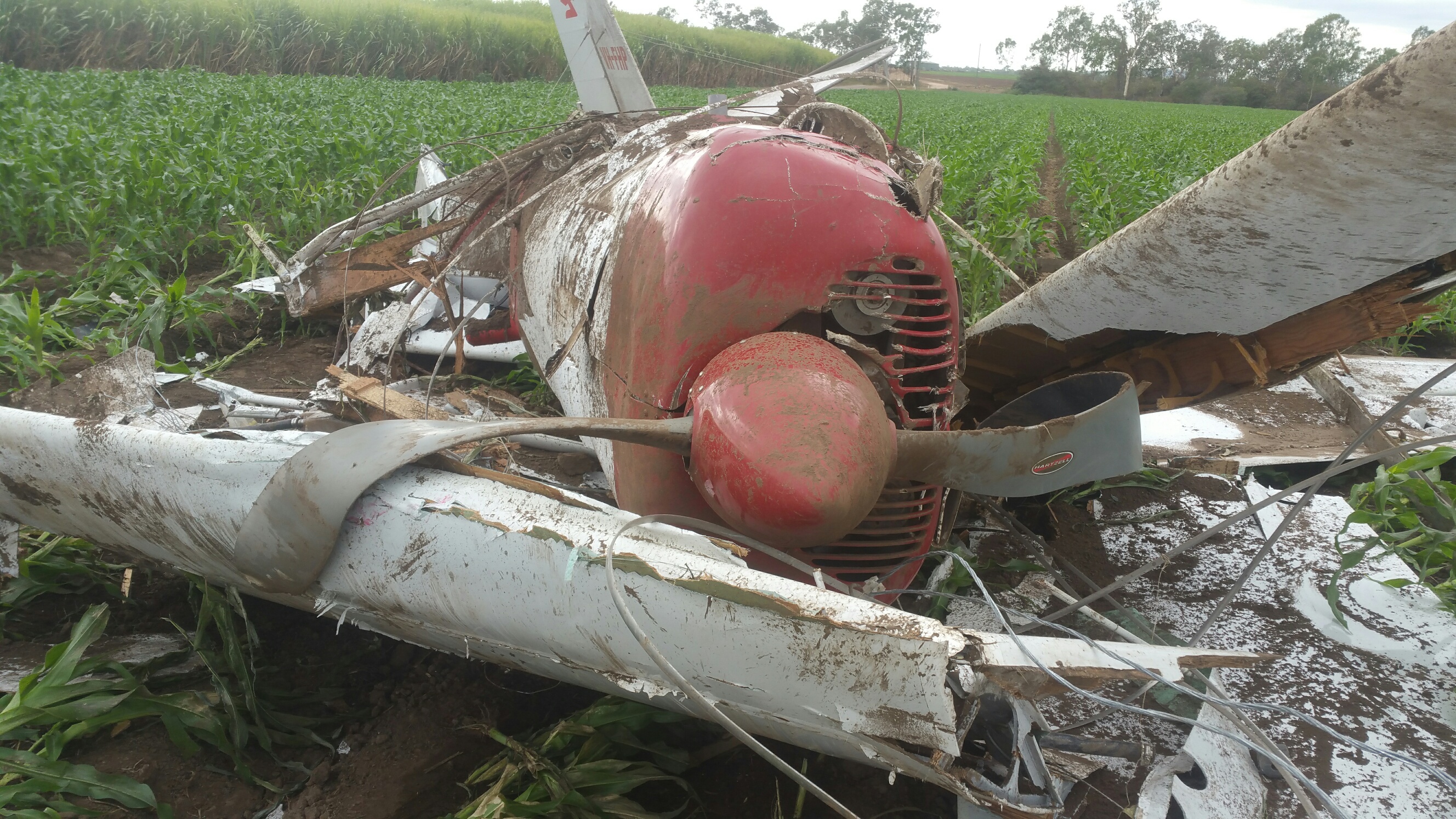 Figure 2: Photo of VH-FHP at the accident site showing damage to the aircraft and wires